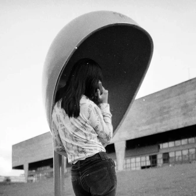 Chu Ming Silveira com o orelhão instalado na FAU USP, anos 70 Chu Ming Silveira com o orelhão instalado na FAU USP, anos 70. Foto: Reprodução/Orelhão